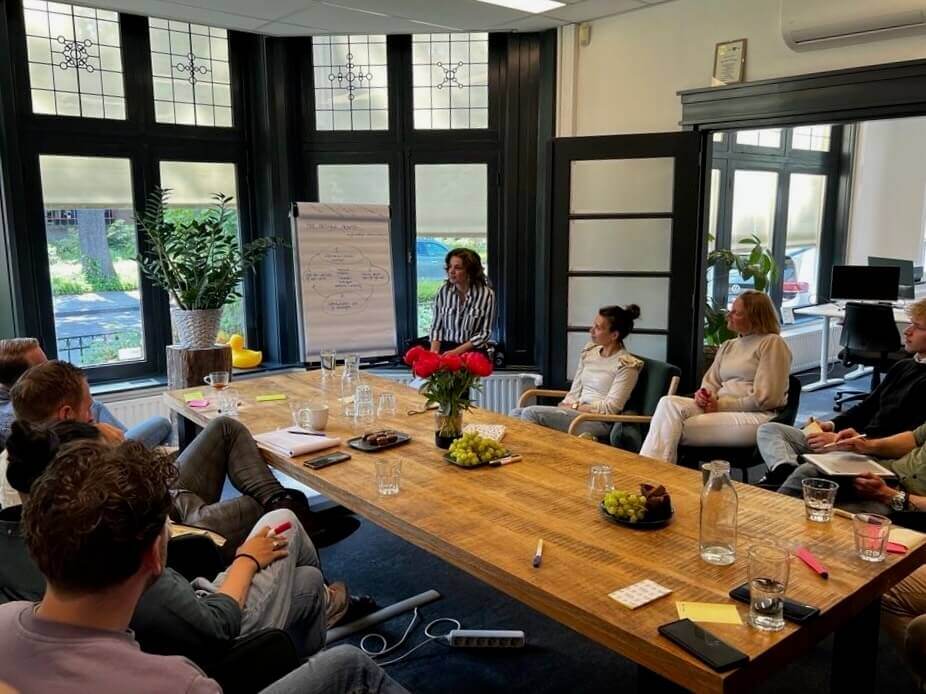 The Bricklog sits together around a table for a brainstorming session